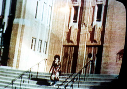 Real People TV show clip of Kellie Everts descending the stairs of Our Lady of Mount Carmel Church in New York City , the priest of which gave Kellie the cold shoulder for her career as a stripper.