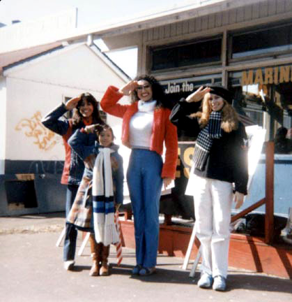 Kellie, dressed in American red, white & blue outfir with other women's activists, both women and children. Sexy Stripper and her fighting female colleagues saluting the US military in front of Brooklyn Arny & Navy recruiting center for Women's Rights in the Defense of Our Country
